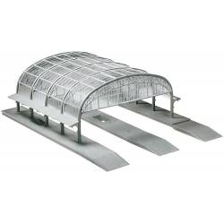 Plataforma da estação com telhado de vidro.