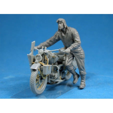US soldier pushing motorcycle.