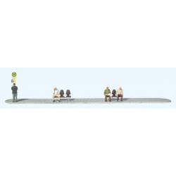 People waiting at the bus/tram stop.